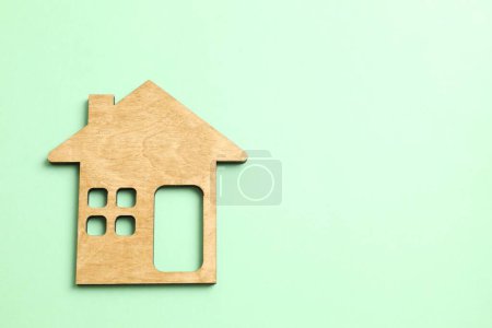 Wooden house on color background