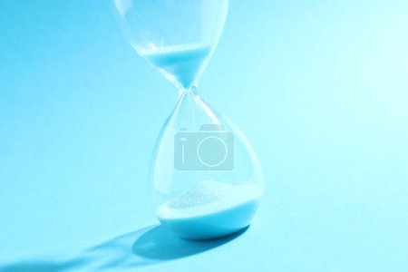 Modern hourglass on color background. Hourglass time concept for business deadline, urgency and outcome of time.