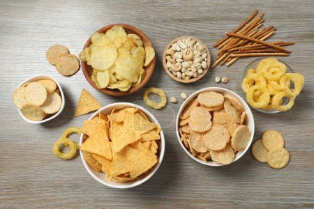 Various unhealthy snacks on wooden background
