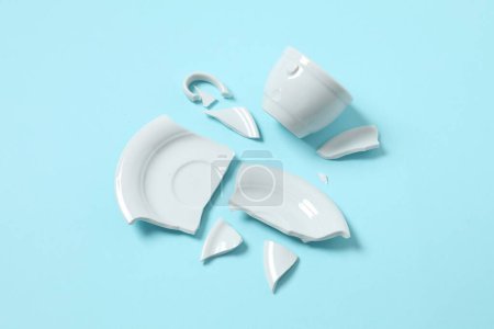 Photo for White cup and plate broken on the table - Royalty Free Image