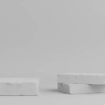 Product Podium - White Stone Podiums, White Wall Background. 3D Illustration