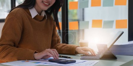Photo for Asian Business woman working at home office and analyze financial report document. Accounting and Finance concept. - Royalty Free Image