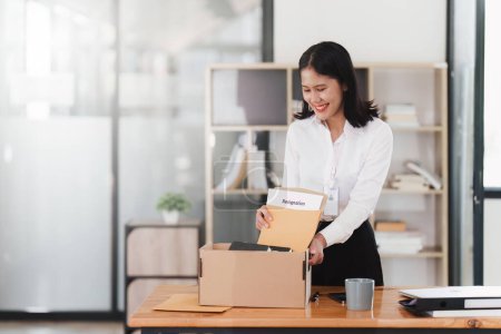 Photo for Resignation concept. Employee holding box of belongings in an office after resignation, Happy moment. - Royalty Free Image