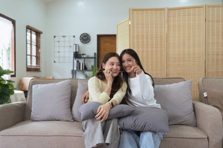 Photo for Asian lesbian woman couple enjoy watch TV together in house and feel happy watch movie on television. Homosexual-LGBTQ concept.. - Royalty Free Image