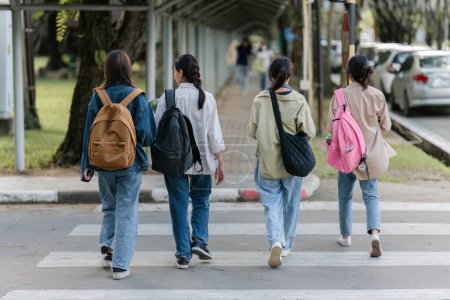 Foto de Group of Young Asian student walking and talking at university before class room. education, back to school concept. - Imagen libre de derechos
