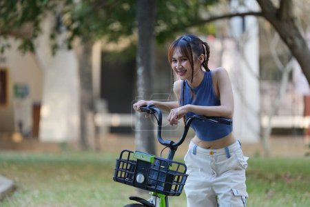 Glückliche asiatische junge Frau fährt Fahrrad im Park, Straßenstadt ihr Lächeln mit dem Fahrrad des Transports, ECO freundlich, Menschen Öko-Lifestyle-Konzept.