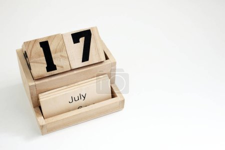 Photo for Wooden perpetual calendar showing the 17th of July - Royalty Free Image