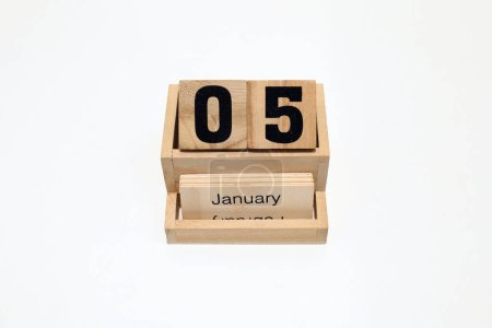 Close up of a wooden perpetual calendar showing the 5th of January. Shot close up isolated on a white background 