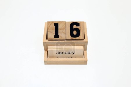 Close up of a wooden perpetual calendar showing the 16th of January. Shot close up isolated on a white background 
