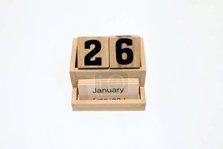 Close up of a wooden perpetual calendar showing the 26th of January. Shot close up isolated on a white background 