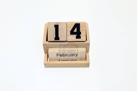 Close up of a wooden perpetual calendar showing the 14th of February. Shot close up isolated on a white background 