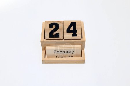 Close up of a wooden perpetual calendar showing the 24th of February. Shot close up isolated on a white background 