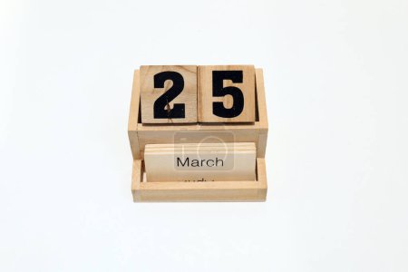 Close up of a wooden perpetual calendar showing the 25th of March. Shot close up isolated on a white background