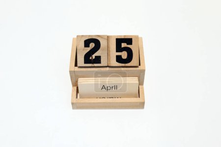 Close up of a wooden perpetual calendar showing the 25th of April. Shot close up isolated on a white background