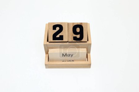 Close up of a wooden perpetual calendar showing the 29th of May. Shot close up isolated on a white background