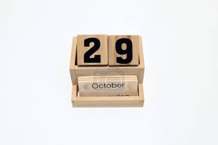 Close up of a wooden perpetual calendar showing the 29th of October. Shot close up isolated on a white background 