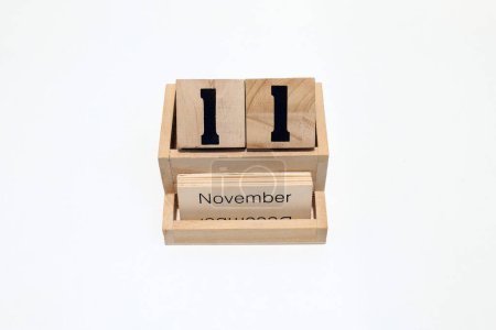 Close up of a wooden perpetual calendar showing the 11th of November. Shot close up isolated on a white background 