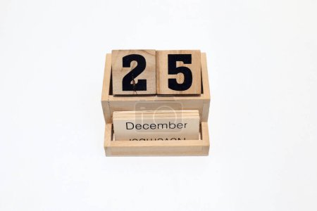 Close up of a wooden perpetual calendar showing the 25th of December. Shot close up isolated on a white background 