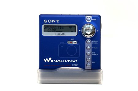 Photo for Bradford, UK 04 05 2024 Retro vibrant blue portable Sony minidisc player isolated on a white background. Playing an untitled track - Royalty Free Image