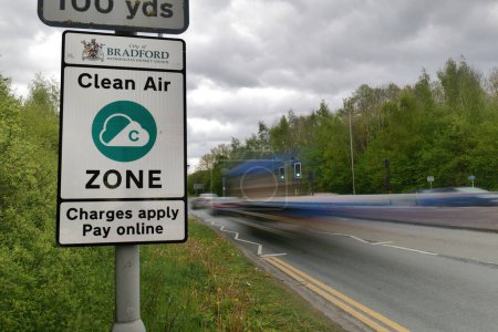 Photo for Bradford, UK 04 29 2024 Clean Air Zone Sign, long exposure with vehicles blurred as they enter the zone - Royalty Free Image