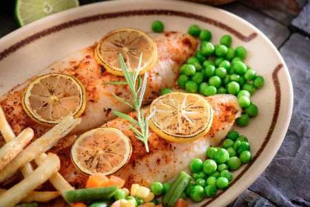 Photo for Flavorful Delight: Cajun Style Baked Fish Fillet with Fries and Lemon in Exquisite 4K Close-Up - Royalty Free Image