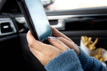 Foto de Conectado conmutar: Primer plano de conducción de coches hombre con el uso de Smartphone en 4K - Imagen libre de derechos