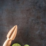 Zesty Citrus Delight: Close-Up of Lemon and Lime Fruit with a Wooden Hand Tool Squeezer, Capturing the Freshness in 4K Resolution