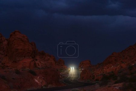 Photo for Night Symphony: Mesmerizing Long Exposure Shot of Traffic on Mountain Road at Arches National Park, Utah, Showcased in Stunning 4K - Royalty Free Image