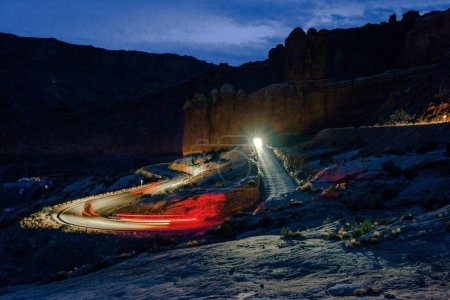 Photo for Night Symphony: Mesmerizing Long Exposure Shot of Traffic on Mountain Road at Arches National Park, Utah, Showcased in Stunning 4K - Royalty Free Image