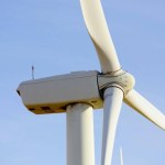 Low Angle View of Wind Turbine Against Blue Sky - 4K image