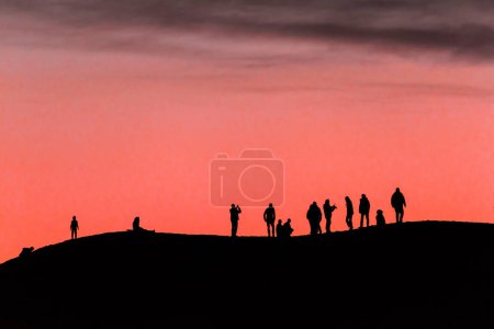Sunset Gazing: Silhouettes of People Admiring the Sunset (4K Ultra HD)