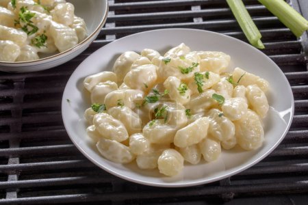 Creamy Comfort: 4K Ultra HD Image of Gnocchi in Cream Sauce and Cheese