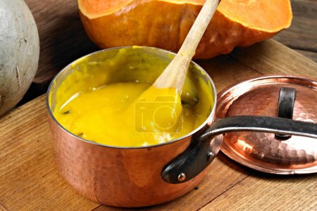Savory Comfort: 4K Ultra HD Image of Close-Up of Pumpkin Soup in Copper Pot