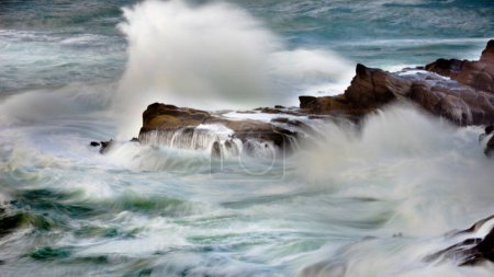 Dynamic Seascape: 4K Ultra HD Image of Ocean Wave Crushing Rocky Shore in Long Exposure