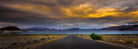 Desert Serenity: 4K Ultra HD Image of Desert Road Leading to Lakeshore with Clouds at Sunset
