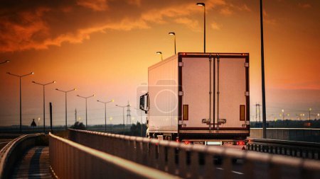 Sunny Day Drive: Closeup Front View of White Cargo Truck Maintaining Max Allowed Speed on Clear Highway (4K image)