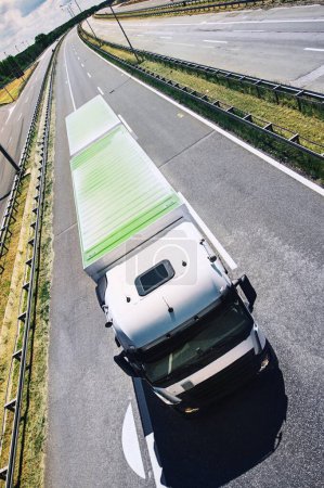 Sunny Day Drive: Closeup Front View of White Cargo Truck Maintaining Max Allowed Speed on Clear Highway (4K image)