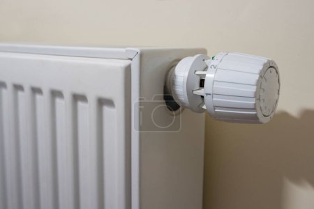 Photo for Heating radiator against yellow wall. - Royalty Free Image