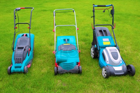 Photo for Lawn mowers standing in the backyard in a sunny summer day, a close-up. - Royalty Free Image