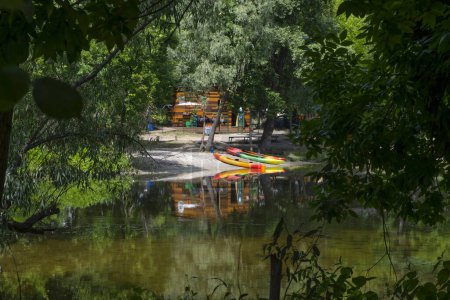 Kayaks, boats on the river bank. Beautiful nature. Healthy lifestyle.