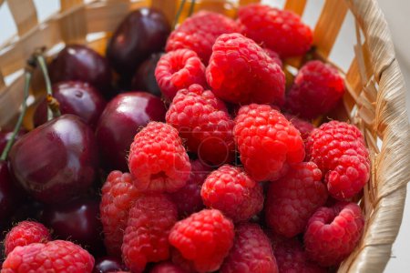 Photo for Raspberries and cherries close-up. - Royalty Free Image