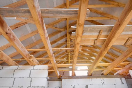 Photo for Construction of a new house roof from wooden beams and aerated concrete. Wooden structure. - Royalty Free Image