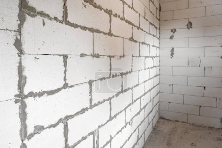Photo for Corner of a brick white wall at a construction site. Construction concept - Royalty Free Image