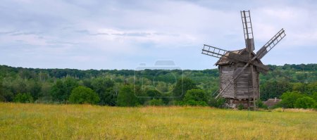 Photo for Old wooden windmill in the middle of the field. - Royalty Free Image
