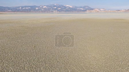 Photo for The effect of the lake drying up in the summer season of extreme weather and heating wave, Climate change and Drought effect. Burdur Yarsl Lake in Turkey. - Royalty Free Image