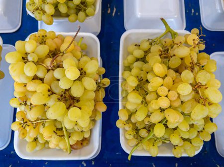 Photo for Grapes sold in bowls on the stall at the local peasant market. - Royalty Free Image