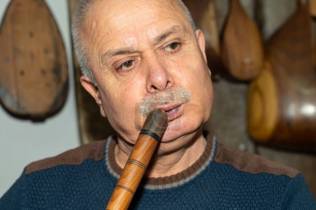 Photo for Man playing woodwind musical instrument wooden pipe. Turkish name "kaval" - Royalty Free Image