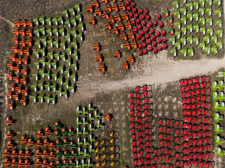 Aerial view of the storage area of coloured balers produced by a factory.