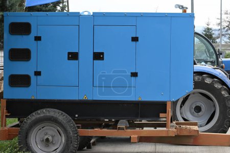 Blue coloured generator placed on a trailer.