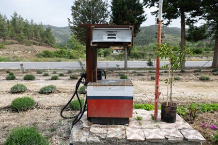 An old and abandoned gas pump at a gas station.